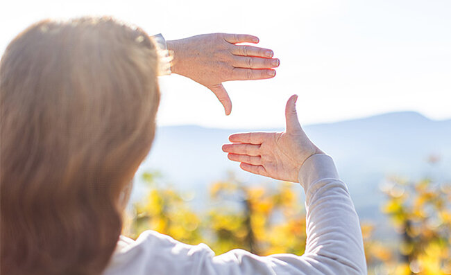 A woman forms a window with her hands